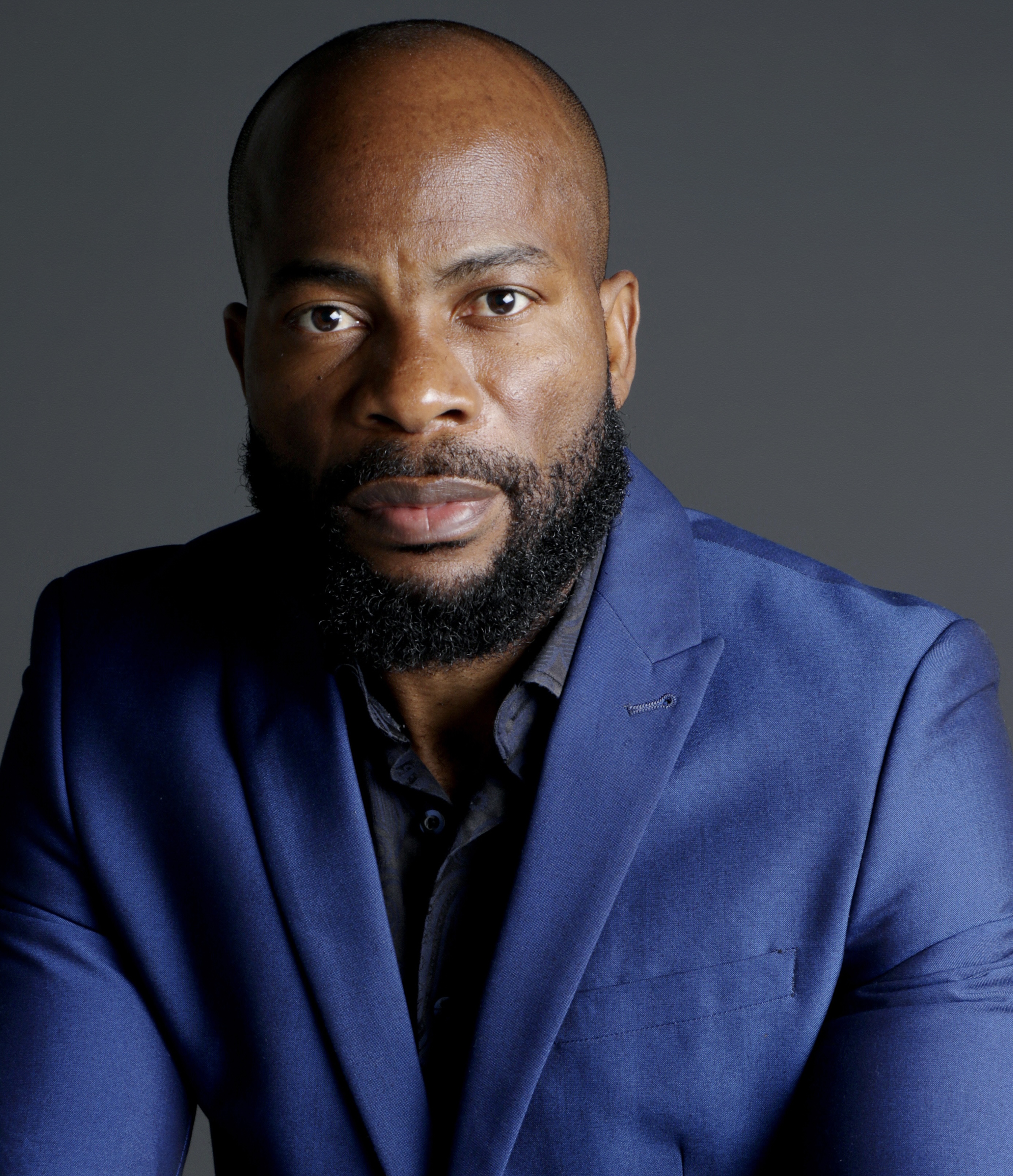 Firefighter rescue holds yellow oxygen tank.